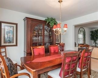 This dining room table is 83" long and 40" wide when the 18" leaf is in place as pictured.  There are 8 chairs, 2 with arms.  The chairs measure 20" wide x 20" deep x 39" high. The breakfront pictured measures 59" wide x 74" high x 18" deep.