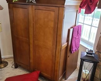 This is a mid-size entertainment cabinet...43.5" wide x 56" tall x 26" deep. It does have adjustable shelving.