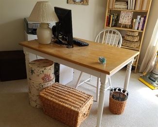 There is a table in the office...light wood with painted white legs. The table measures 30" x 48"