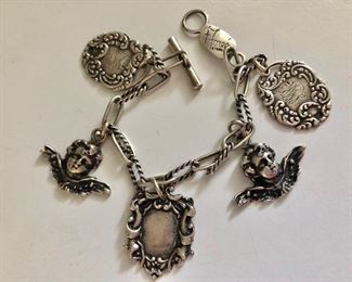 $95 Signed Foree Sterling silver charm bracelet.  3 framed charms and two angels.