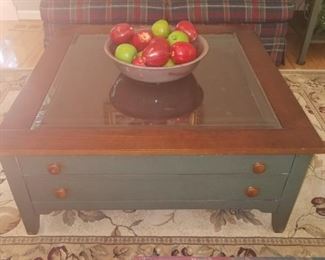 Square glass top coffee table, with two drawers. One of the three piece set.