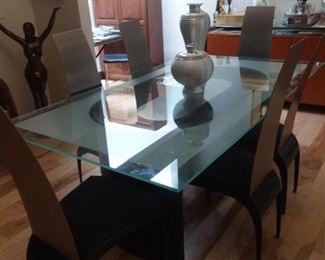 Glass and stainless dining table with six chairs