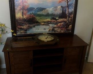 Tv stand, wall clock and art