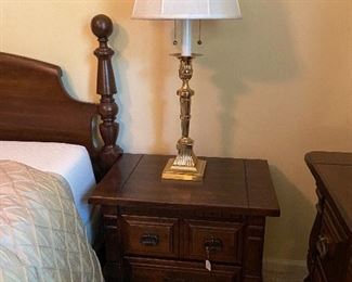 Pair of matching night stands and brass lamps.