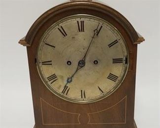 1003 ARCH TOP BRACKET CLOCK WITH CHIME. HAS KEY. 14 1/2 IN HIGH. FRONT GLASS DOOR MISSING, INLAID MAHOGANY CASE
