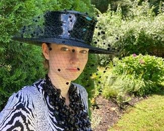 Diane von Furstenberg, black and white printed silk jersey classic wrap dress. Hat: Frank Olive, black straw hat with net veil.