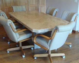 Heavy marble table/base with six leather chairs on casters