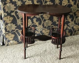 One of a kind kidney shaped table with spindle compartments. Use it however you like.