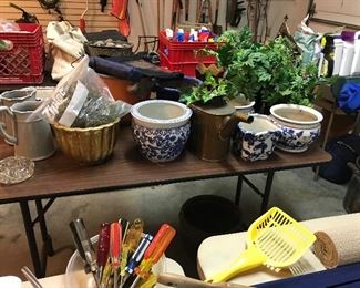 Pots and watering pitchers, greenery