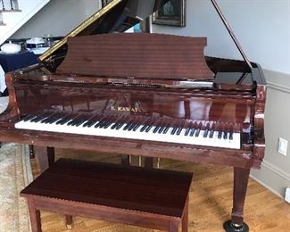 Elegant K Kawai Bay Grand Piano with bench. Mahogany finish with strong grain. Beautiful Response and touch. Cared for by McQuary.