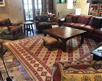 10x12 Dhurrie rug, four count swivel rocking arm chairs, mesquite coffee table, leather sectional sofa, and wonderful accent tables