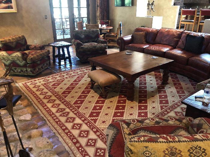 10x12 Dhurrie rug, four count swivel rocking arm chairs, mesquite coffee table, leather sectional sofa, and wonderful accent tables