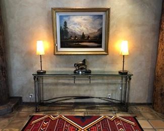 Fantastic seven foot long console table with arrow legs and two bows as cross stretchers, beveled glass top.  Parchment table lamps, bronze and the Heinie Hardwig oil.