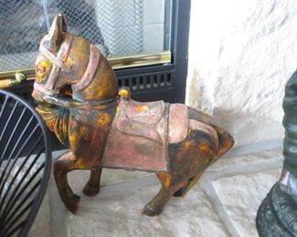 Carved wood horse with copper saddle and reins