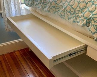 Foot of bed hides computer desk.