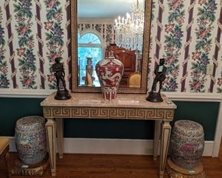 Greek key painted wood console table, with travertine top, with large Asian porcelain urn, with lid, vintage metal figurines of Ivanhoe and Quentin Durward and nice pair of Asian porcelain Familia Rose garden stools. 