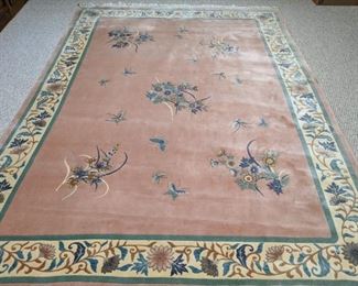 Plush, vintage Chinese 120-line wool rug, in purdy pink, with floral border. 