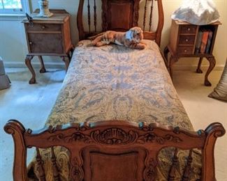 Kid's room, with an antique French single bed, flanked by a pair of refinished side tables.
