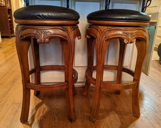There are four of these wood/leather swivel barstools.