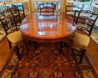 Vintage Henredon dining table, with two 14" leaves, with all table pads, set of six 1940's mahogany chairs, all atop a Persian design hand-woven wool rug. 