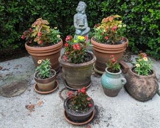 A nice collection of terra cotta pots, all watched over by the wistful concrete girl.