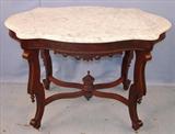 452 - Walnut Victorian Turtle top center table with white marble, ca. 1870, 43in Wide, 27in. Deep