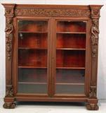 307 - R.J. Horner Mahogany Bookcase in orig. finish w standing ladies on each side, ladies faces on feet, untouched, all original, 67 in. T, 63 in. W, 18 in. D