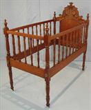 407 - Walnut Victorian Baby Bed with spindle sides and carved crown with grapes, 47 in. T, 43 in. L, 24 in. W, ca. 1875