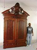 107 - Walnut Victorian Heavily Carved Wardrobe with tall pierced carved crown, att. Mitchell & Rammelsberg.