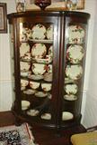 116 - Oak Bow glass Claw Footed China Closet, 68in. T, 49in. W.
306 - Large Set of Franciscan Ware, 71 pieces with serving pieces, ca. 1950.