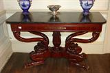 720 - Mahogany Empire console Table with black marble top, bronze inlay, dolphin head in base, has writing drawer that pulls out, 34in. T, 58in. W, 24in. D, ca. 1840.