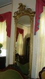186 - Tall Gold Victorian Hanging Mirror with Victorian head in crown, 83in. T, 30in. W, ca. 1870.