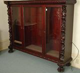 110 - Figural Carved Mahogany 3 door Bookcase, tagged Paine Furniture, ca. 1890, 78in. W x 60in. T.