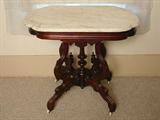 122 - Walnut Marble Top Center Table with nicely carved base, 29 in. T, 32 in. L, 22 in. D.