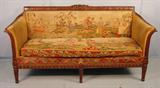 208 - Mahogany Heavily Carved Sofa with needlepoint seat and back of Austrian scene, 36in. T, 72in. L, 28in. D, ca. 1910. This Sofa also has an original 8 x 10 photograph of advertisement, dated 1910.