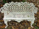 741a - Cast Iron Victorian Love Seat, with head in back crown, 32in. T, 44in. L, 15in. D, ca. 1880.