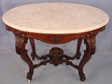 214 - Walnut Victorian Turtle Top Parlor Table with carved fruit basket finial, white marble top, 37in. W, 22in. D, ca. 1855