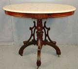 410 - Oversized Victorian Oval Top Rosewood Center Table, carved legs, white marble top, attributed to William McCracken ca. 1870, 39in. W, 28in. D, 31in. H.