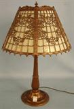 440 - Early Paneled Slag Glass Lamp with intricate metal work and tan glass, ca. 1900, style of Miller