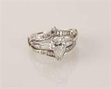 122 - Large Solitaire Pear Shaped Diamond Ring with ornate diamond guard, all set in platinum.