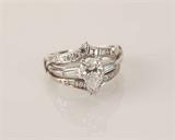 122 - Large Solitaire pear Shaped Diamond Ring with ornate diamond guard, all set in platinum.