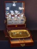 140 - 19th Century Tantalus Set with original bottles and stoppers, complete, in mahogany string inlay box.