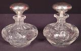 174 - Pair of cut Glass Bottles with sterling stoppers.
