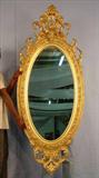 311 - Oval Rococo Gold Gilt Mirror with original finish, 68in. T, 29in. W, grapes in crown, ca. 1850.
