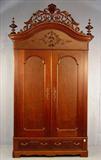 256 - Monumental Victorian Wardrobe, walnut with carved crest, turned finials, made by Mitchell and Rammelsberg, Ohio, ca. 1870, 60in. W, 24in. D, 115in T.