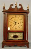453 - Pillar and Scroll clock with broken arch top and brass finials, bracket feet and reverse painted glass, ca. 1930, 29in. T, 12in. W.