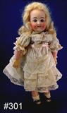 301 - 12in., Holz-Masse, German Bisque Doll with blue eyes, composition body, crochet dress