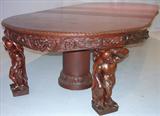 108 - 1911 Dining Room Table by Oriel Cabinet Co. that features massively carved mascarons, Norman soldiers, atlantes and caryatid figures as well as griffins in full relief (part of the "Norman Suite"), 12ft. long (with felt-lined, dovetailed leaf case)