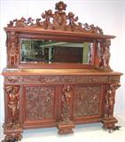 109 - 1911 Sideboard by Oriel Cabinet Co. that features massively carved mascarons, Norman soldiers, atlantes and caryatid figures as well as griffins in full relief (part of the "Norman Suite"), 95in. tall, 82in. wide, 28in. deep