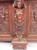 109 - 1911 Sideboard by Oriel Cabinet Co. that features massively carved mascarons, Norman soldiers, atlantes and caryatid figures as well as griffins in full relief (part of the "Norman Suite"), 99in. tall, 82in. wide, 28in. deep (caryatid figure)